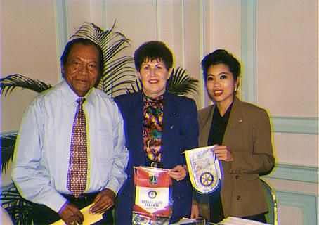 Exchanging Rotary flags at Jakarta meeting